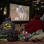 People on West Street Plaza watching a movie outdoors